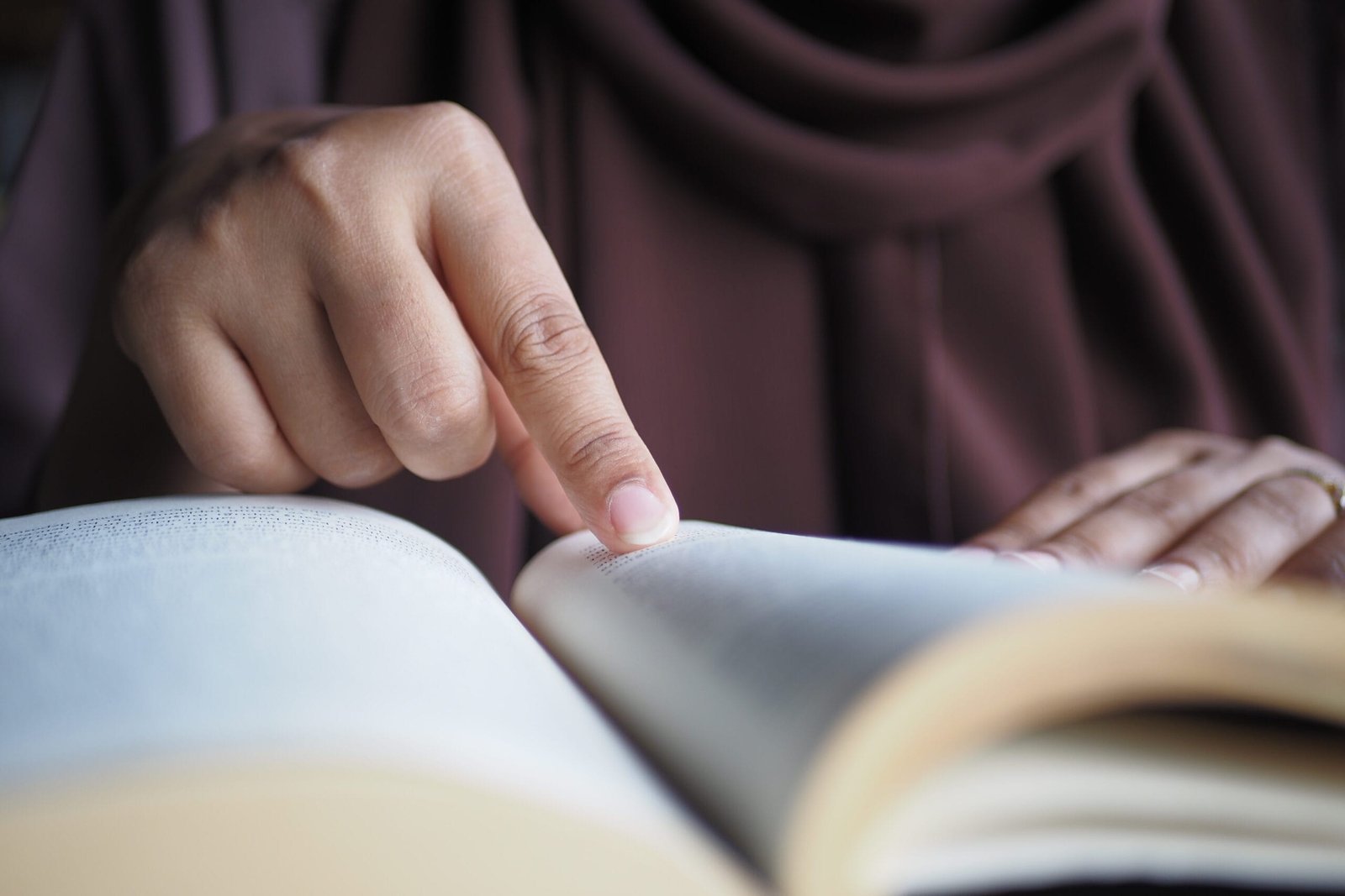 close up of women hand turning a pager of a diary 2024 12 12 02 25 07 utc scaled