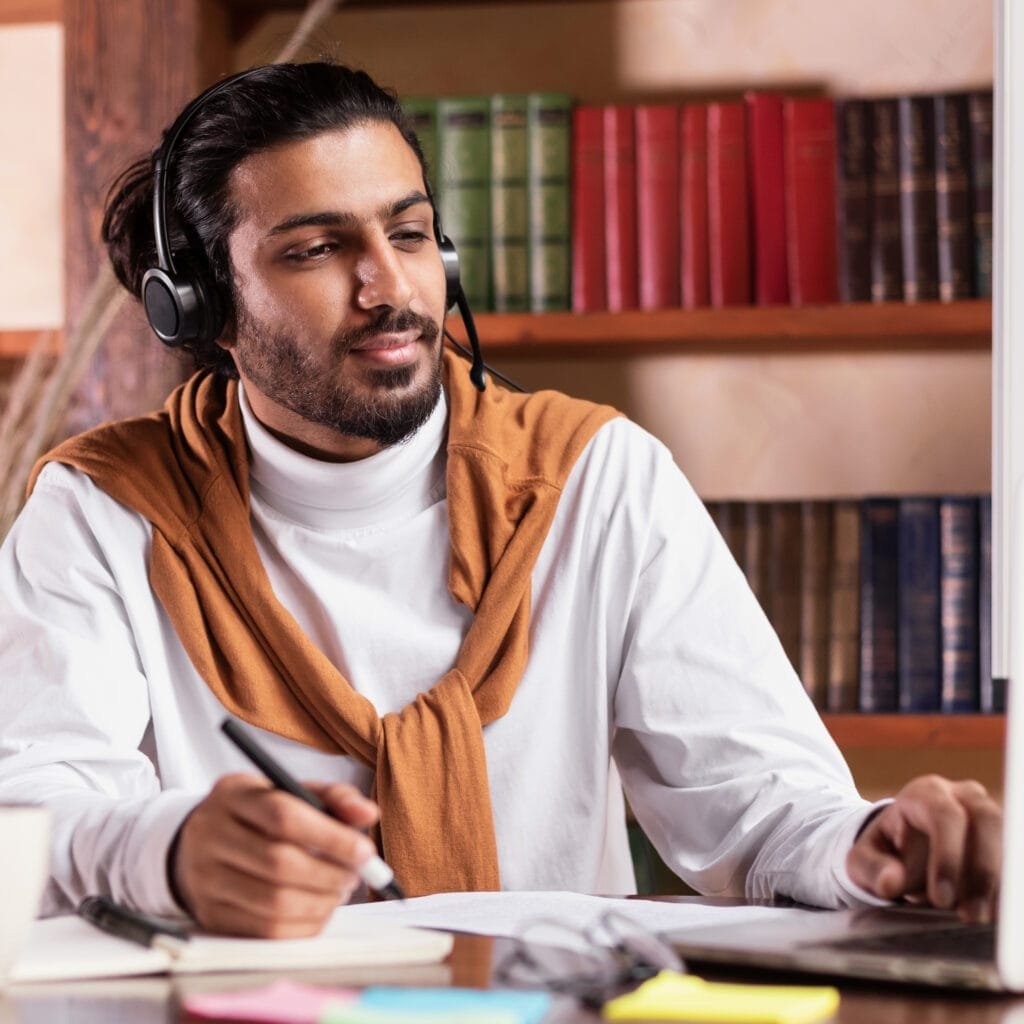 serious indian teacher sitting at laptop wearing h 2025 03 18 18 52 02 utc