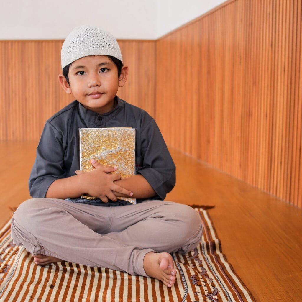 young boy holding the holy qur an 2025 06 23 21 19 04 utc